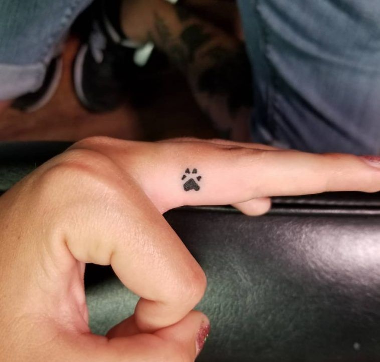 dog tattoo on finger